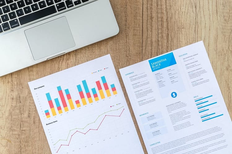 two white printer papers near macbook on brown surface - grow your business
