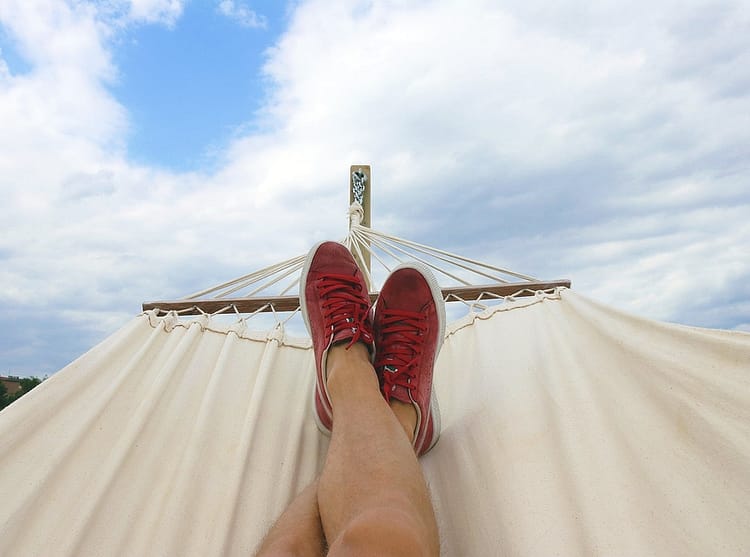 pair of red and white low top sneakers - what is slow living
