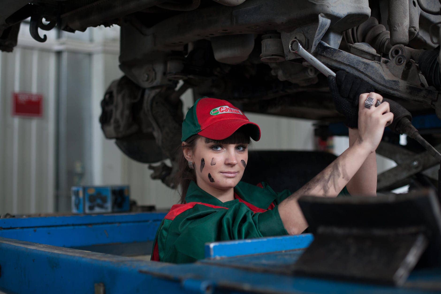 woman holding gray steel wrench - manufacturing machine