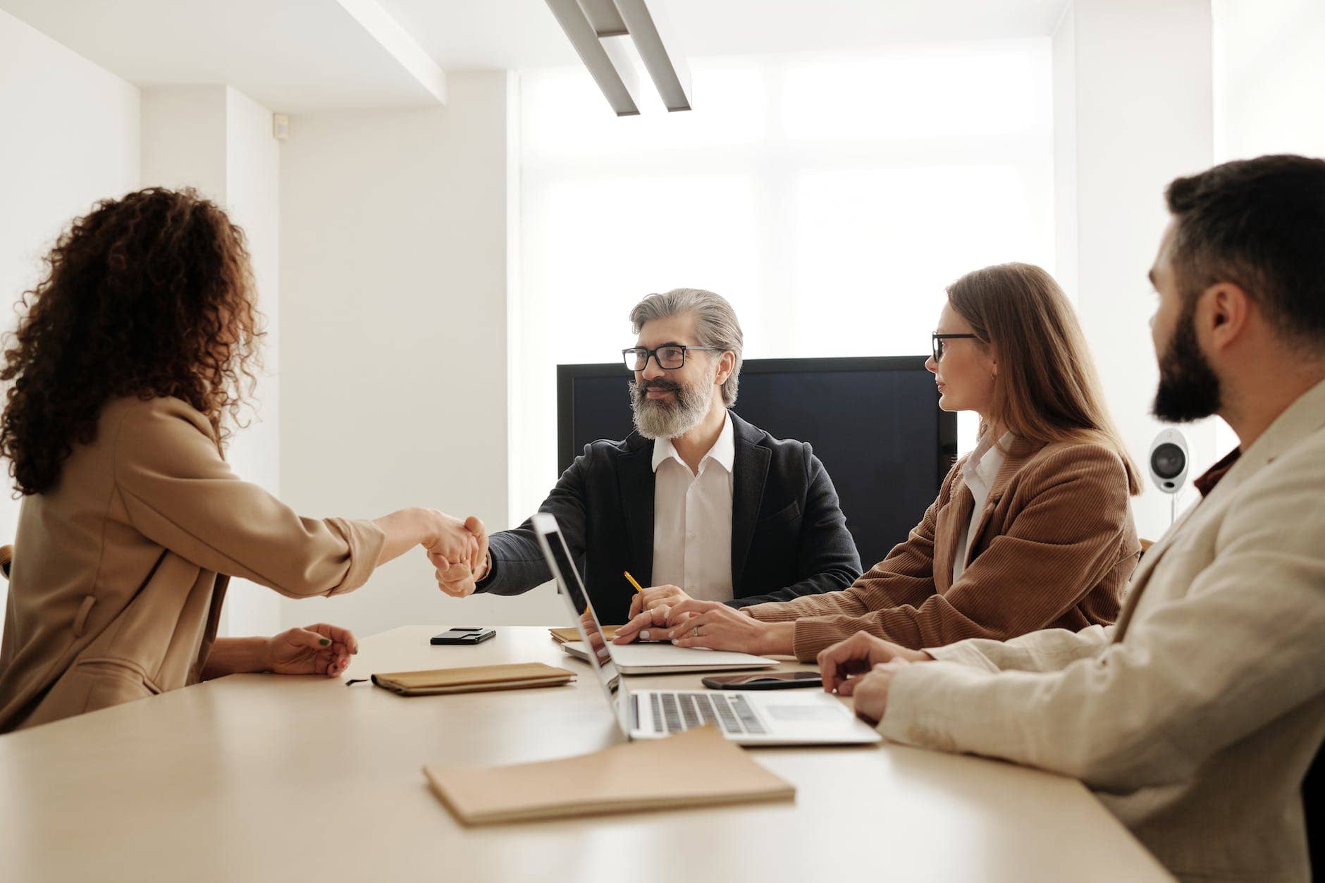 man in black suit jacket sitting beside woman in brown long sleeve shirt - finding the right employee