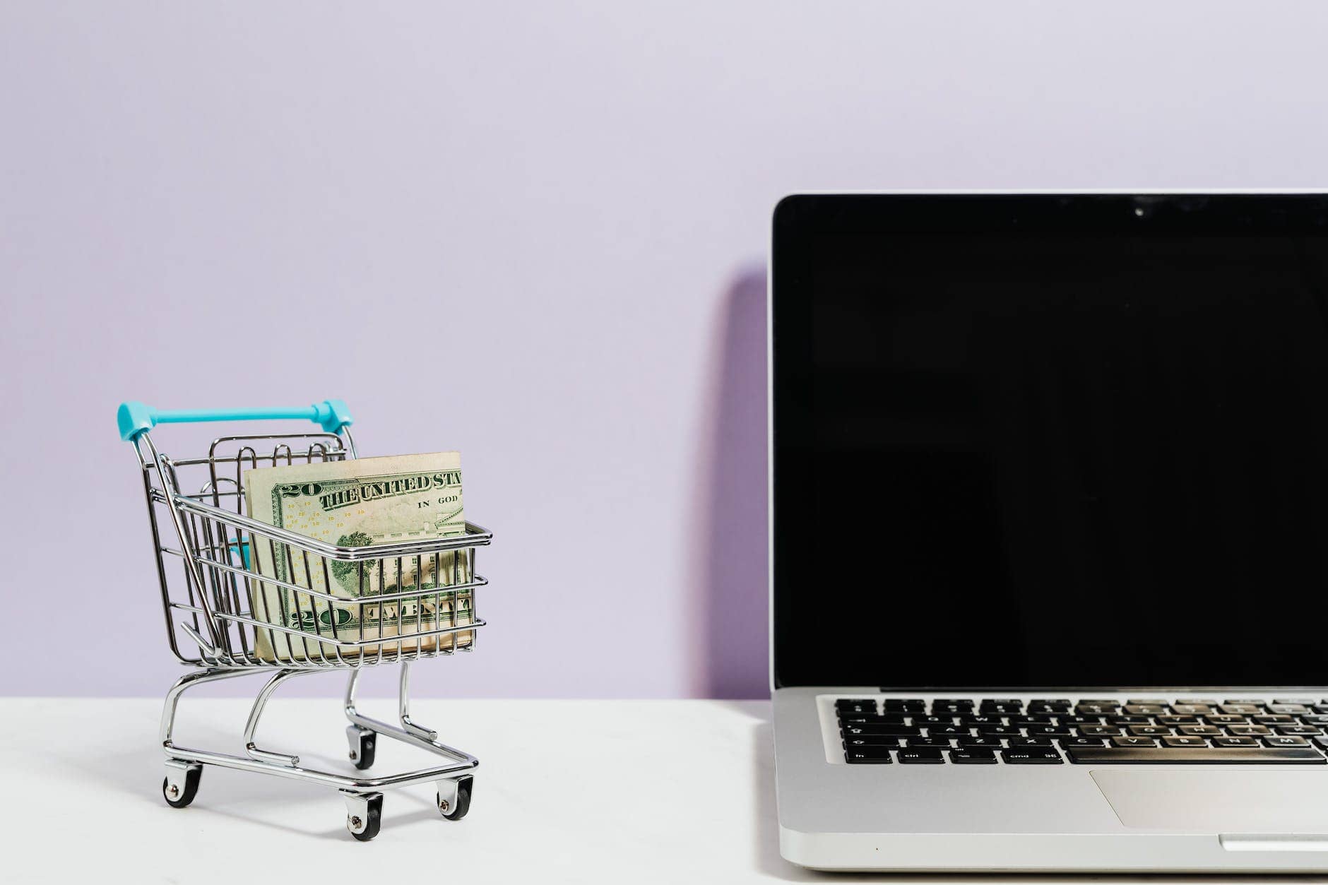 shopping cart next to a laptop - online business