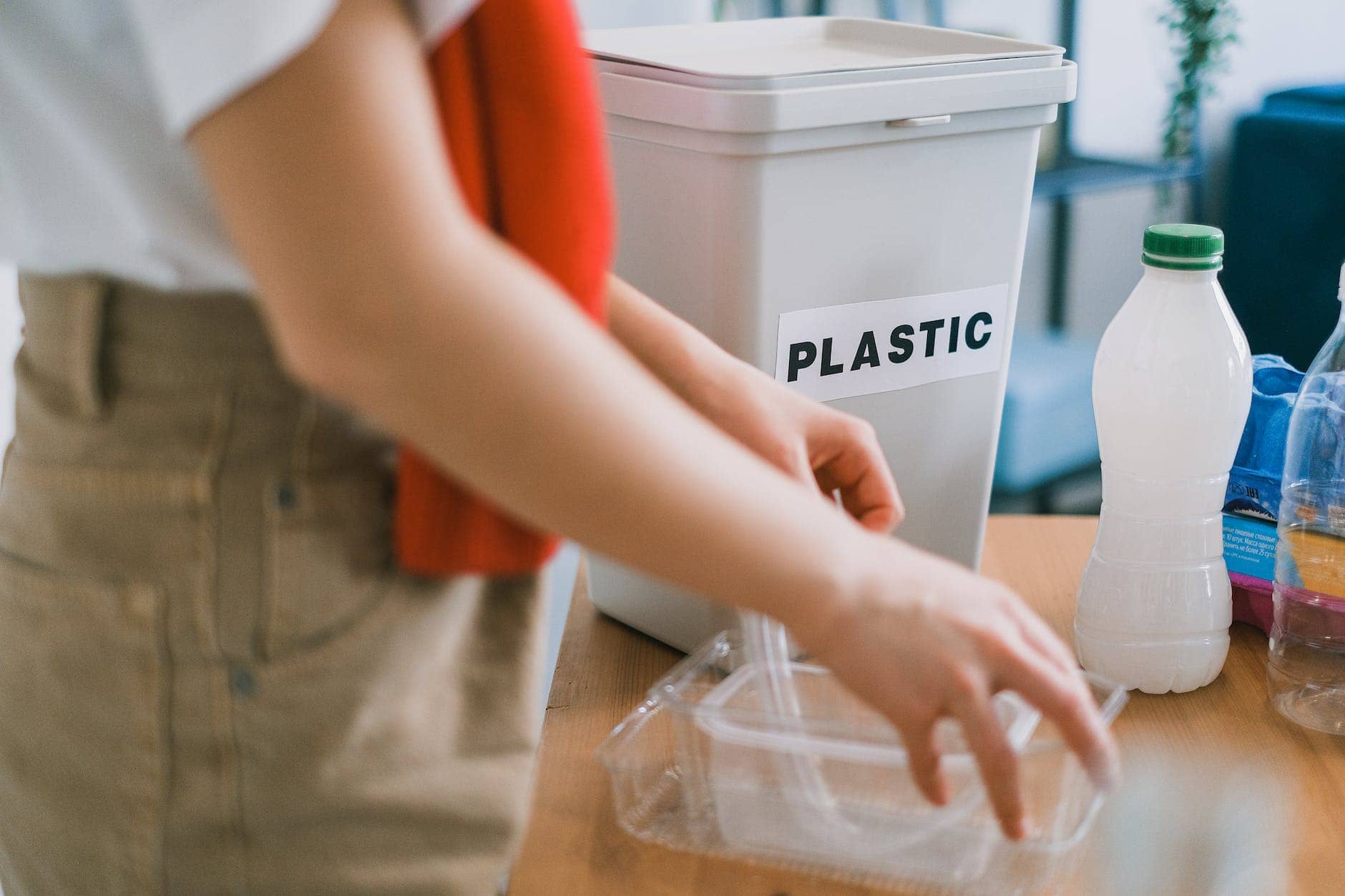 woman in casual clothes sorting plastic garbage - business waste