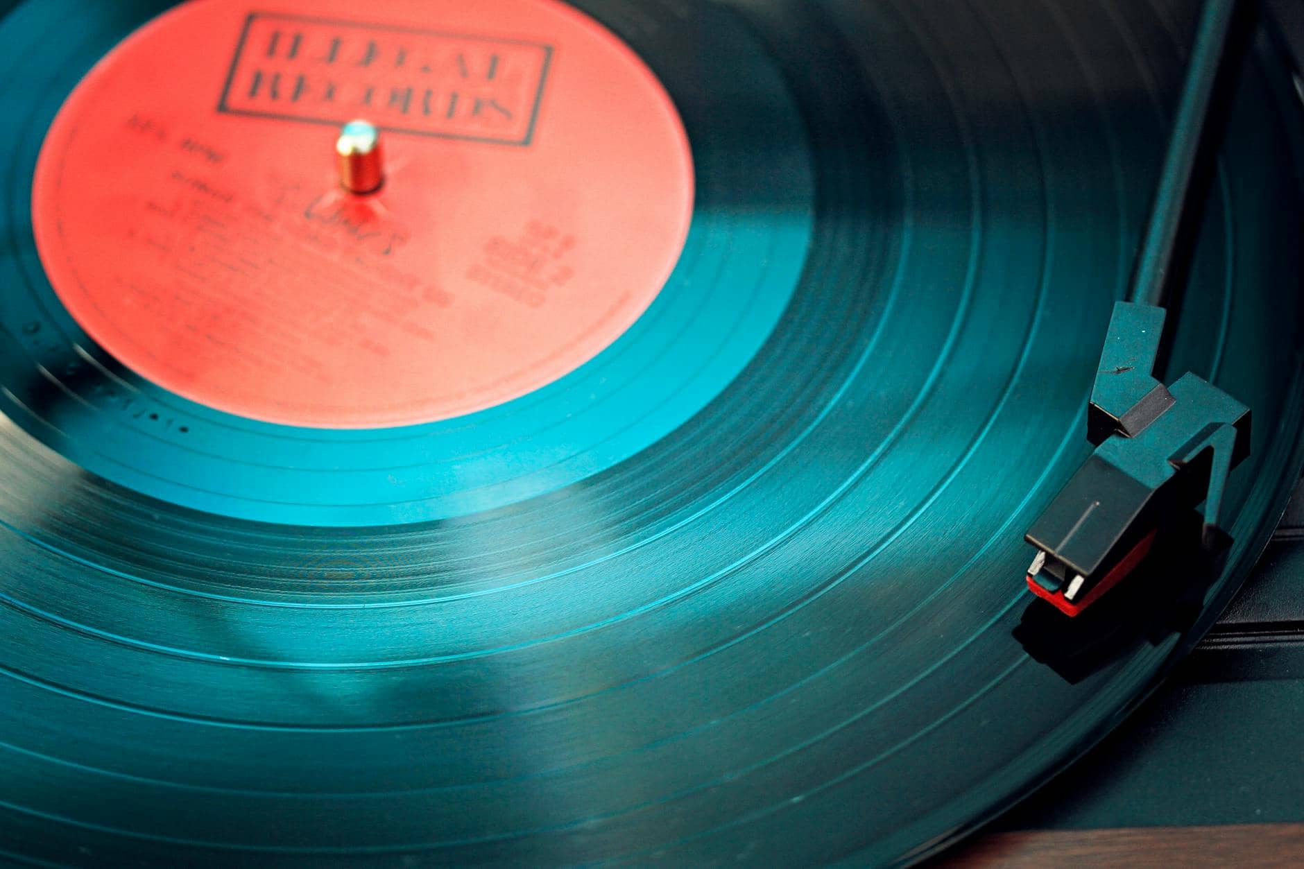 blue vinyl record playing on turntable - new music business