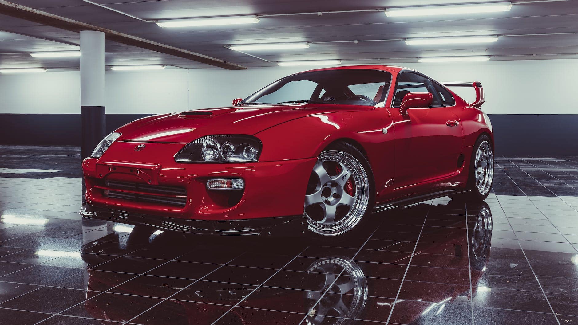 red toyota supra parked at a garage - best sports cars