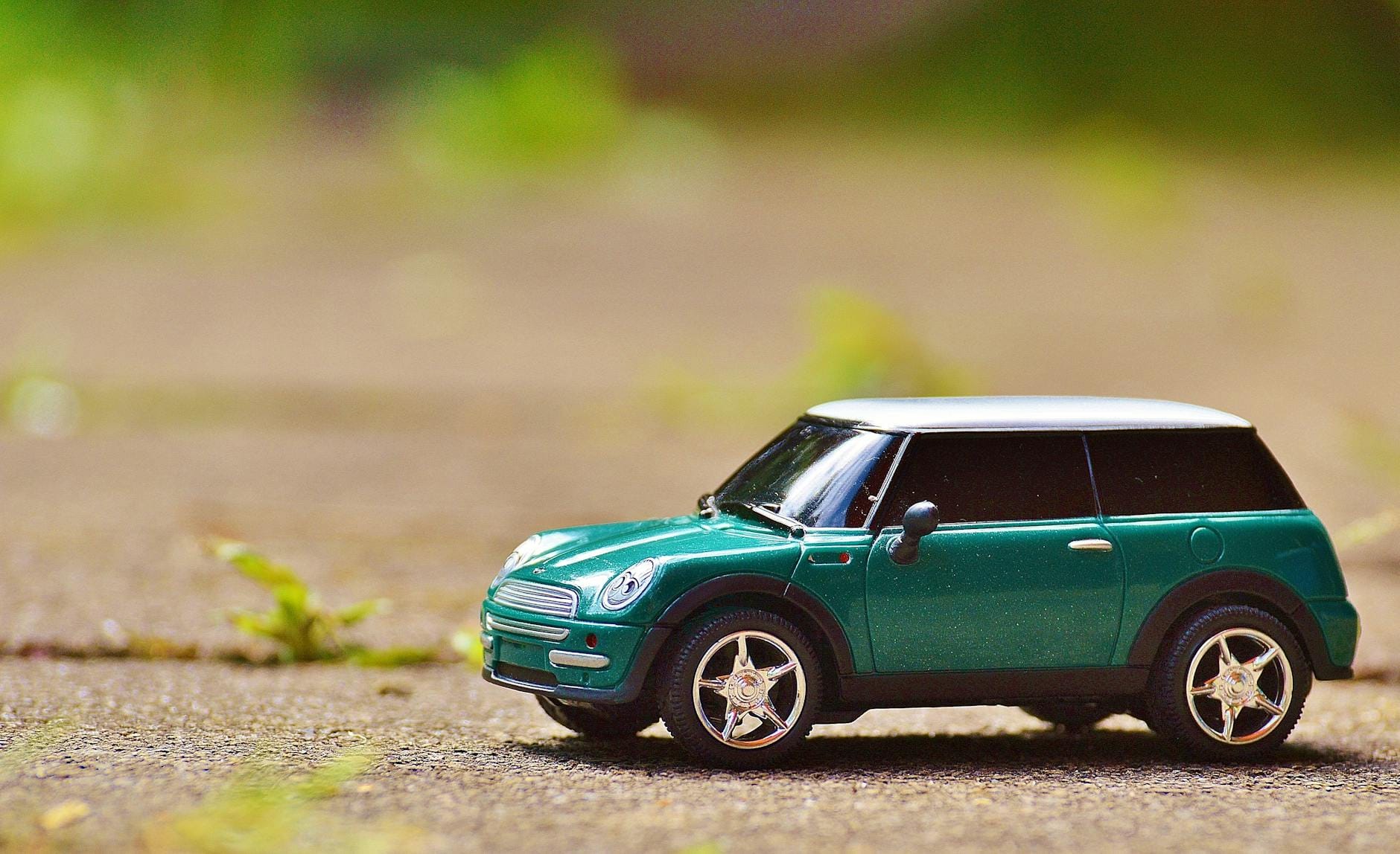 green scale model car on brown pavement - Make Your Car Stand Ou