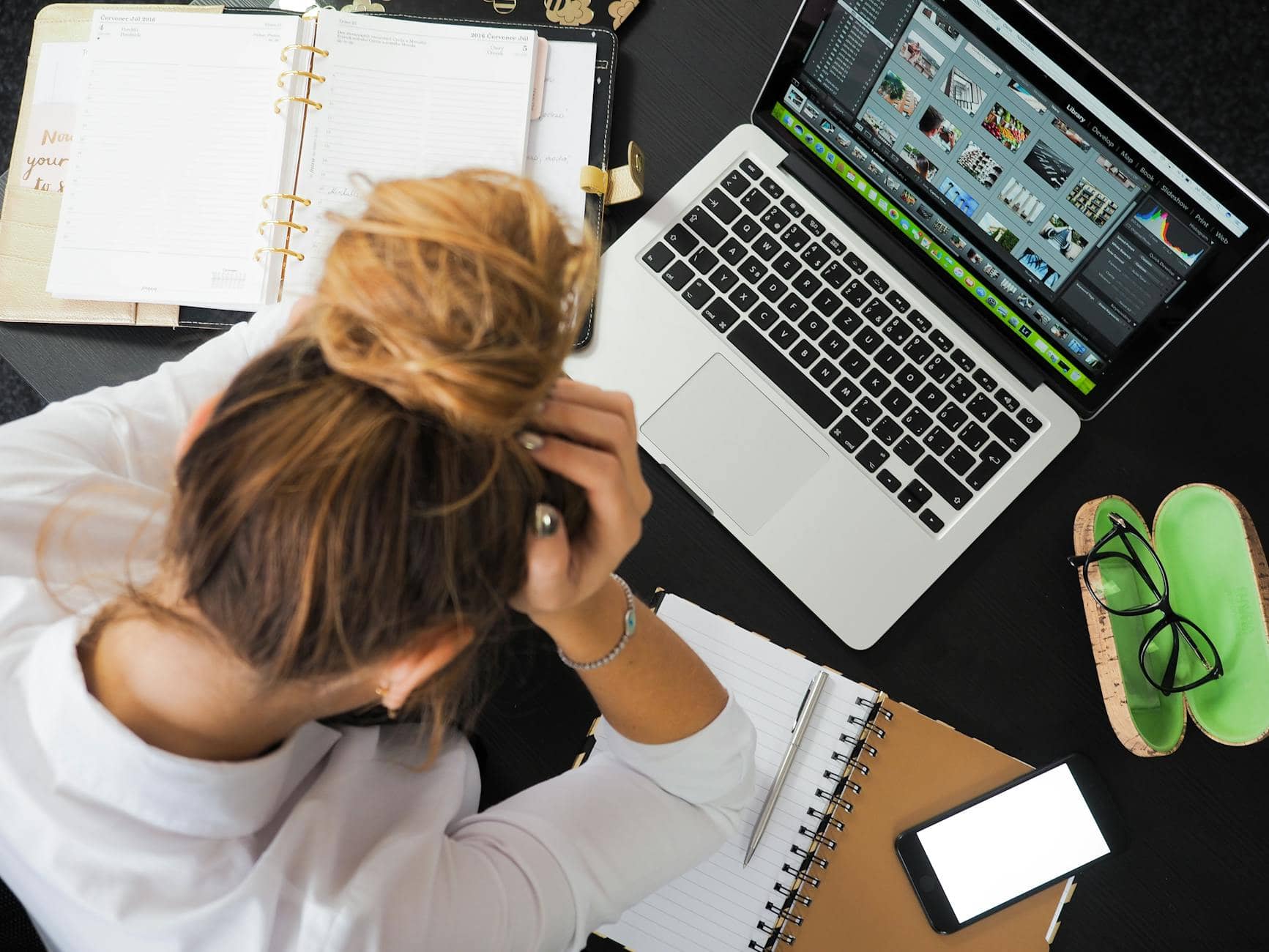 woman sitting in front of macbook - How To Enjoy Your Life As A Business Owner