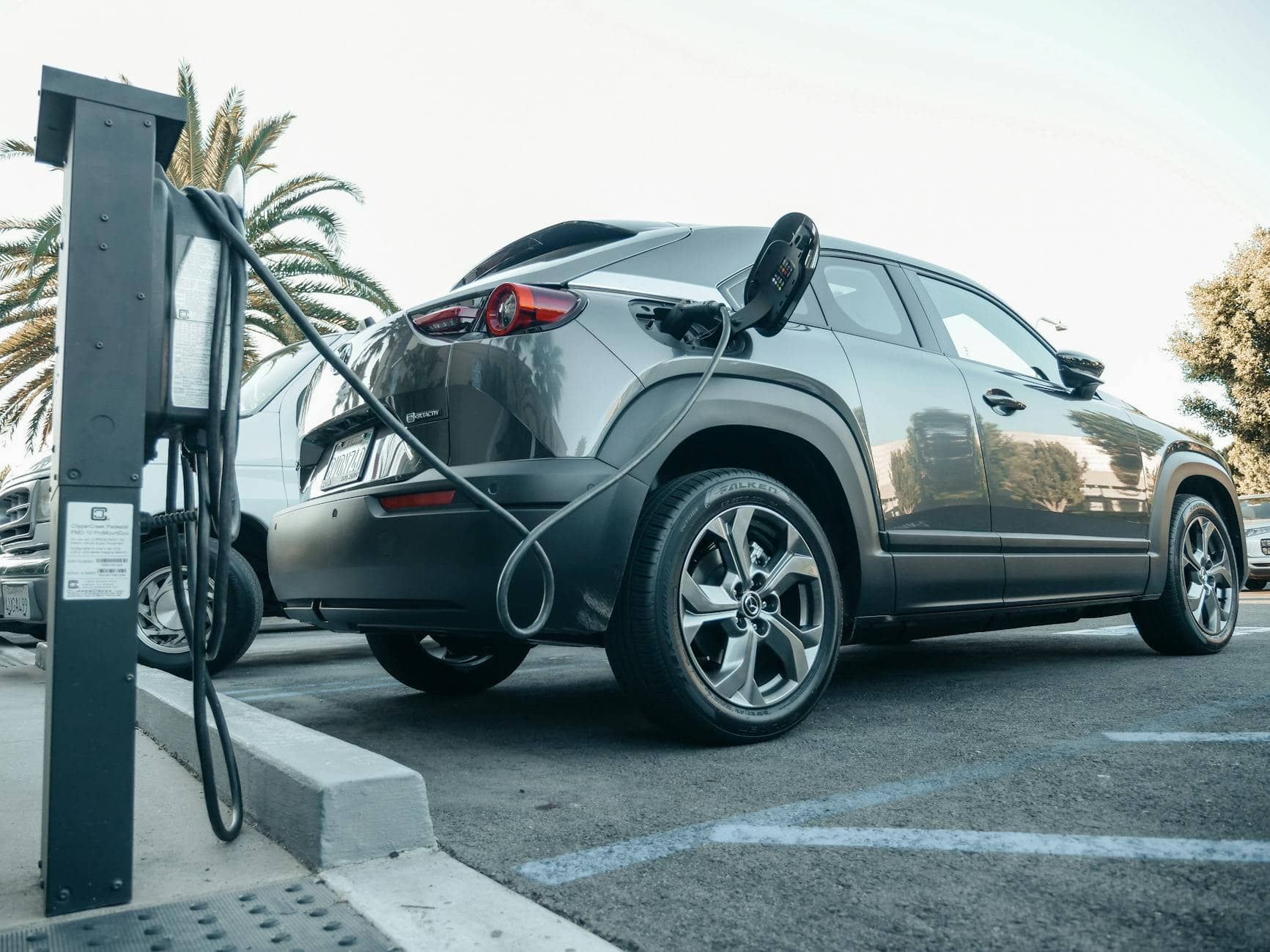 gray electric car parked on a charging bay - buying an electric vehicle