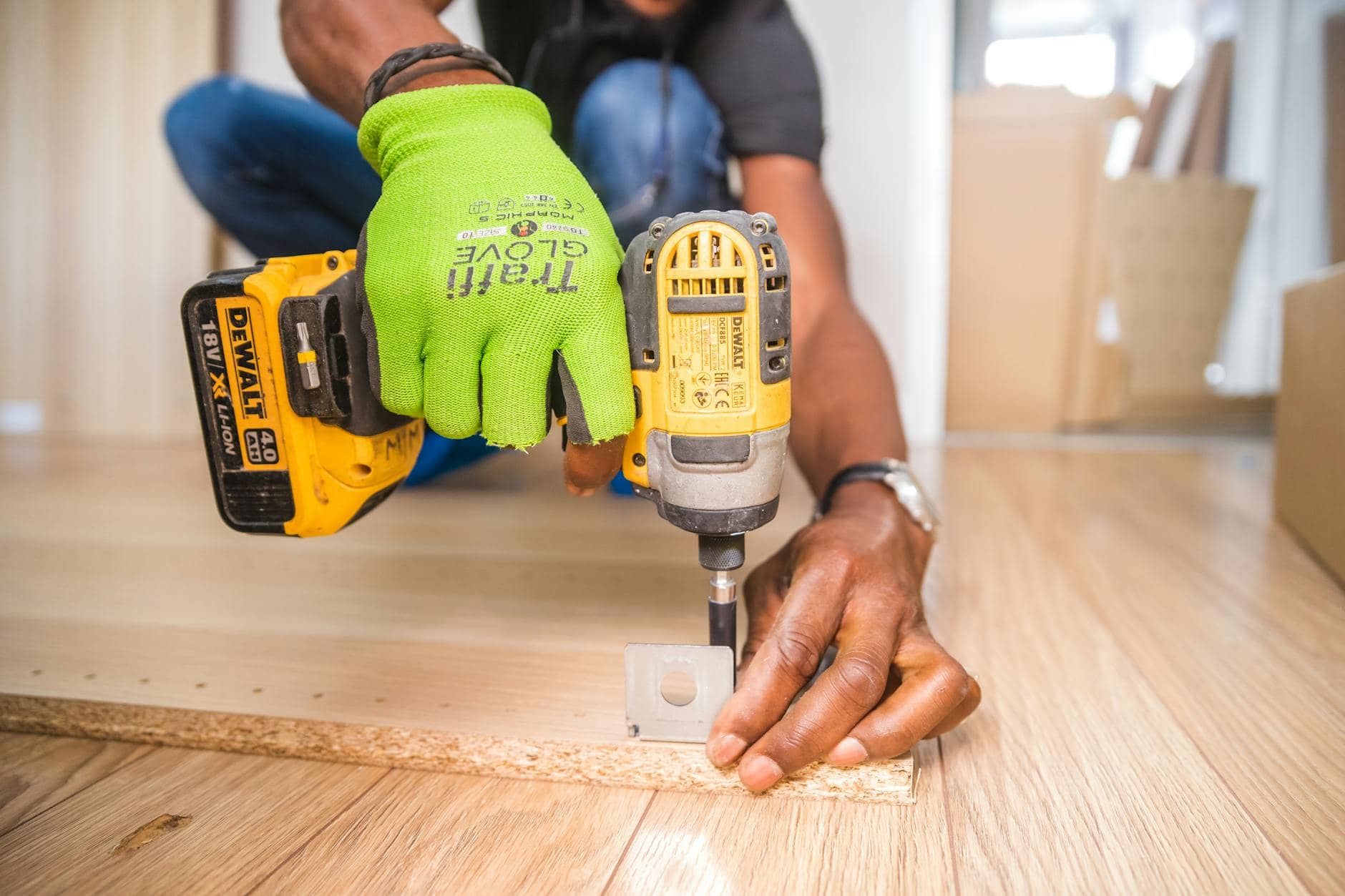 person using dewalt cordless impact driver on brown board -Carpentry Business