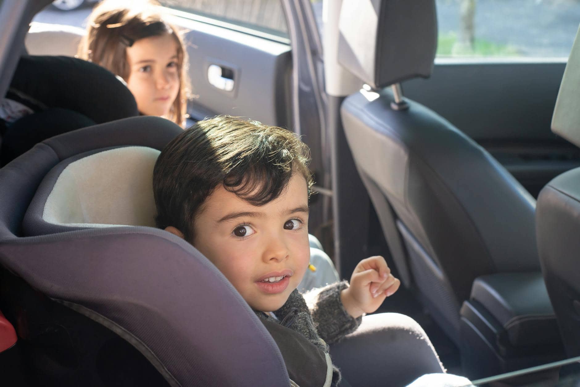 boy sitting on car seat