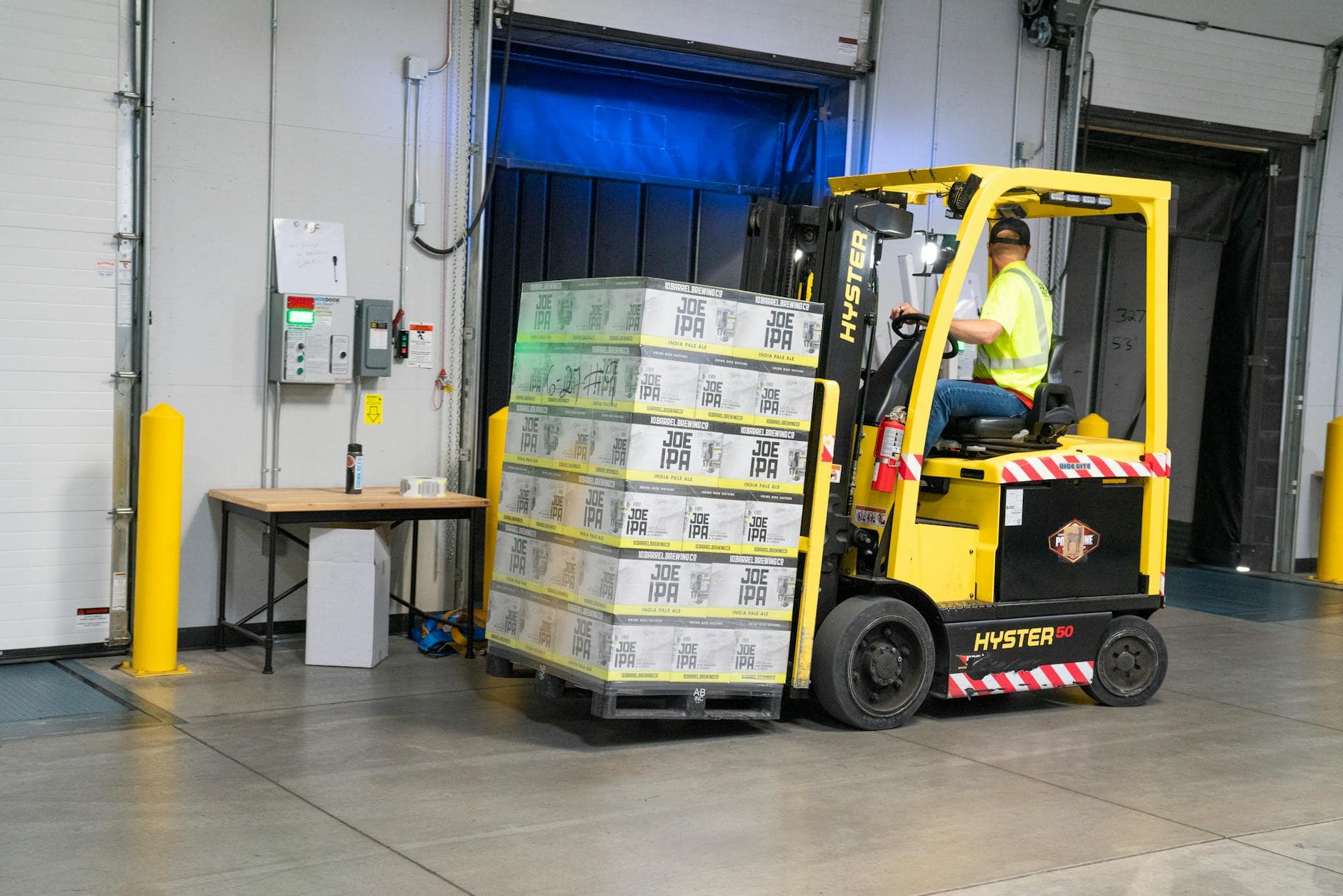 man riding on yellow forklift