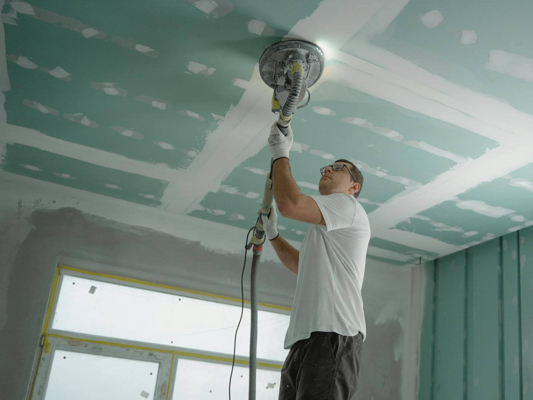 man polishing the ceiling