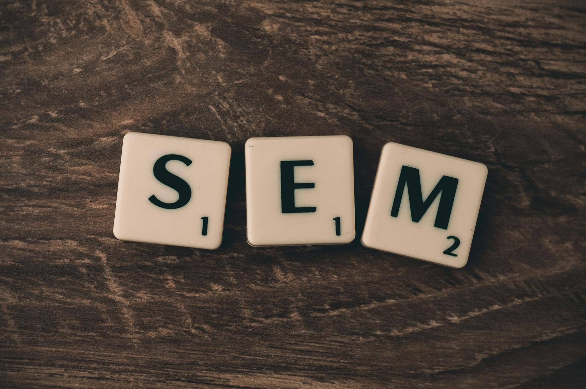 three white s e and m scrabble tiles